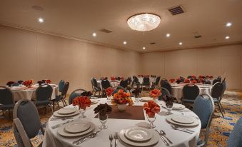 a large , well - lit room with multiple dining tables set up for a formal event or celebration at Best Western Plus Burley Inn Convention Center
