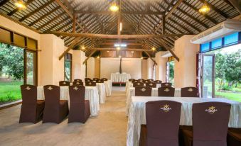 a large , empty banquet hall with multiple rows of chairs and tables set up for an event at Aurora Resort Chiangdao