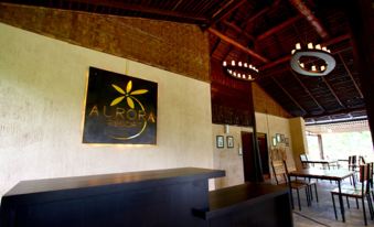 a hotel lobby with a wooden reception desk and a large sign on the wall at Aurora Resort Chiangdao