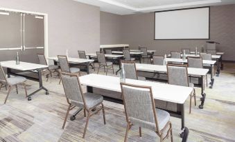 a large conference room with multiple tables and chairs arranged for a meeting or event at Courtyard DeLand Historic Downtown