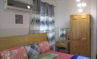 a cozy bedroom with a wooden bed , curtains , and a dresser , bathed in natural light from a window at Luxury Apartment