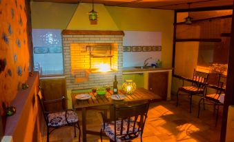 a cozy dining room with a wooden table , chairs , and a fireplace , creating a warm and inviting atmosphere at Titi