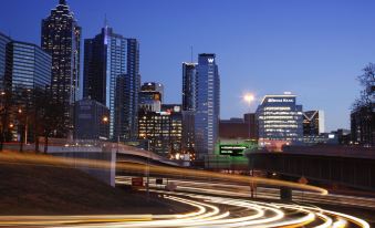 a busy city street at night with tall buildings and a highway in the foreground at W Atlanta – Downtown