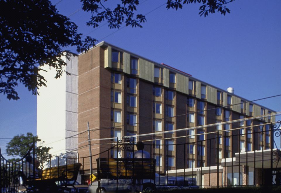 a large building with many windows and a parking lot in front of it , under a clear blue sky at Rodd Grand Yarmouth