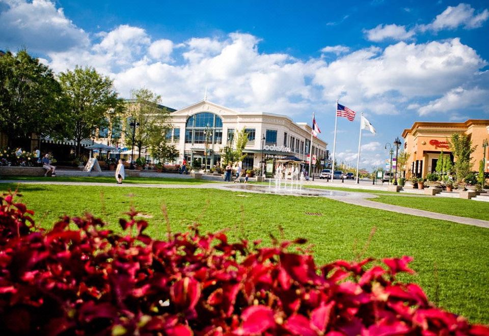 a large building with a green lawn in front of it , surrounded by trees and bushes at Residence Inn Dayton Beavercreek