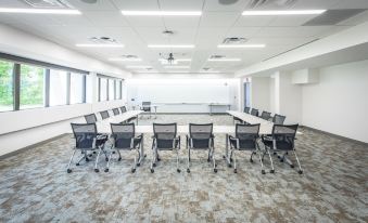 a large conference room with a long table and numerous chairs arranged for a meeting at Inn at Villanova University