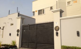 A house with black garage doors and a white painted wood paneling on the front door at Millennium Apartments