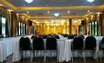 a large conference room with rows of chairs arranged in a semicircle , and a podium at the front at Hugpua Hotel