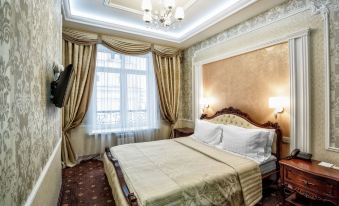 a large , well - lit bedroom with a king - sized bed and a flat - screen tv mounted on the wall at Metropol Hotel