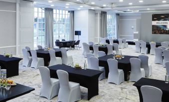 a large , empty banquet hall with multiple tables and chairs set up for a formal event at Forest of Arden Country Club