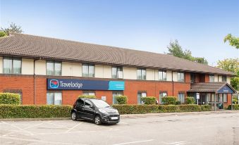 a parking lot in front of a hotel with a car parked in the lot at Travelodge Nottingham Trowell M1