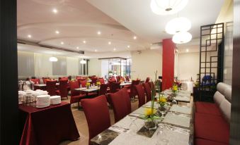 a large dining room with multiple tables and chairs arranged for a group of people at Brentwood Suites