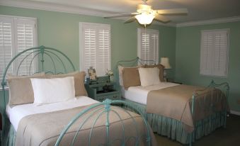 a room with two beds , one on the left and one on the right side of the room at Green Tree Inn