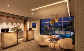 a modern hotel lobby with a large reception desk and comfortable seating areas , creating an inviting atmosphere at Treasure Island Beach Resort