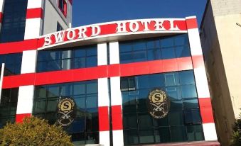 "a red and white striped hotel building with the name "" sword hotel "" prominently displayed on its exterior" at Sword Hotel