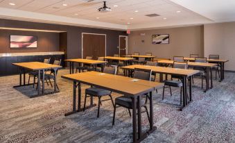 a large conference room with several rows of tables and chairs arranged for a meeting at Courtyard Elmira Horseheads