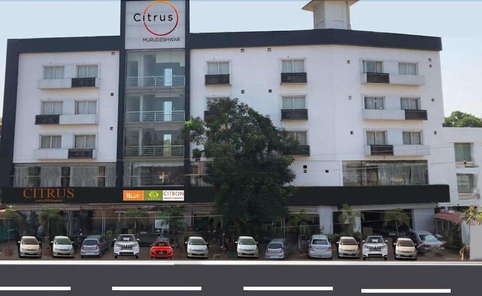 "a modern building with multiple cars parked in front , and the sign "" citrus "" is displayed above" at The Royal Oak Hotel