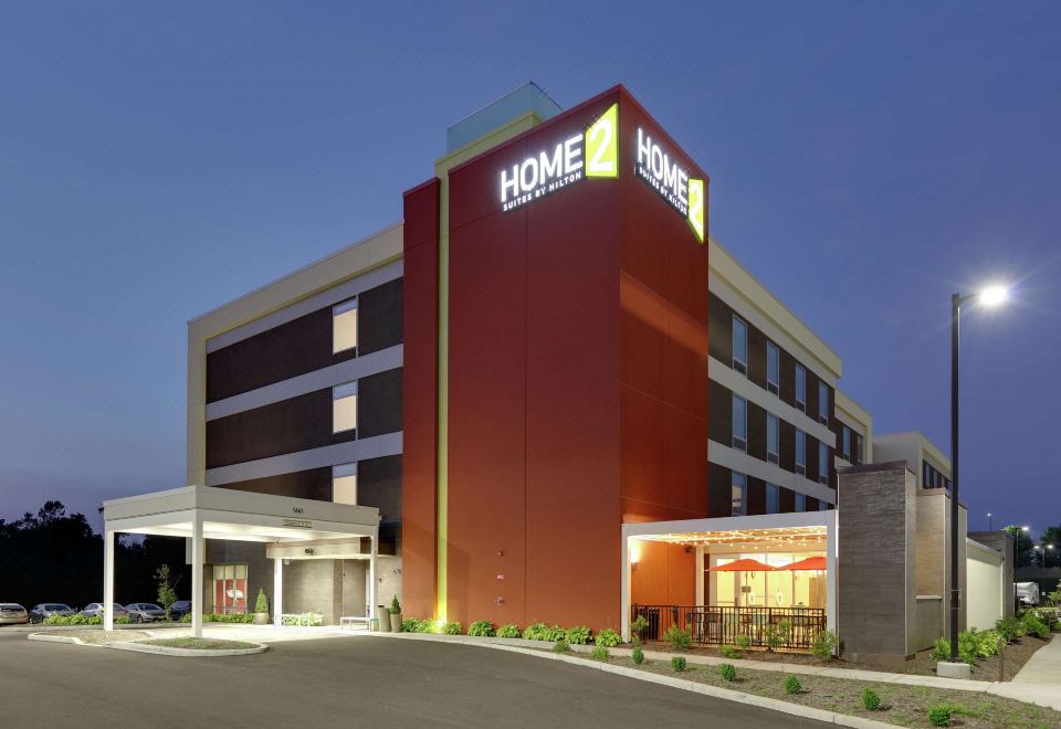 "a large hotel building with the name "" home 2 suites by hilton "" displayed on it , located in a city street at dusk" at Home2 Suites by Hilton Hagerstown