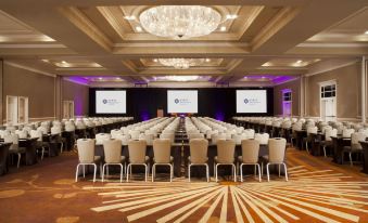 a large conference room with rows of chairs arranged in a semicircle , ready for a meeting or event at Hyatt Regency Long Island