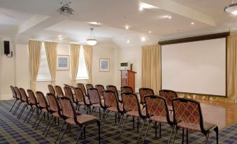 a conference room with rows of chairs arranged in a semicircle , ready for a meeting or presentation at Jenolan Caves House