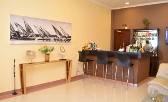 a well - decorated hotel lobby with a bar and seating area , as well as a large painting on the wall at Hotel Oceano