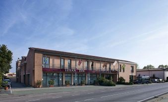 "a large building with a sign that reads "" hotel "" is situated on a street corner" at Best Western Titian Inn Hotel Venice Airport