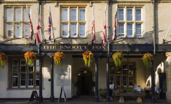 "a brick building with a large sign that reads "" the snooty fox "" on the front" at The Snooty Fox