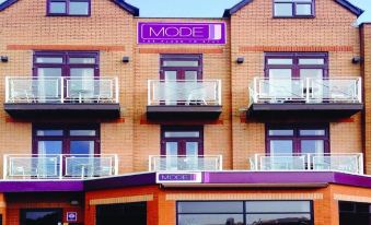 "a building with a purple sign that says "" mode "" and balconies , located in a city" at Mode Hotel St Annes