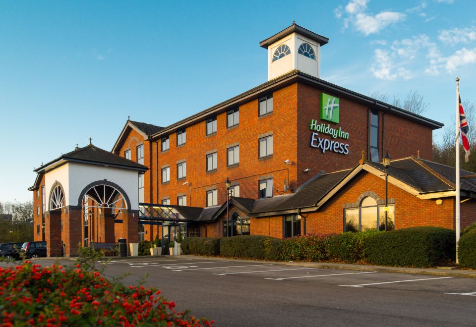 "a brick building with the words "" holiday inn express "" prominently displayed on the front of the building" at Holiday Inn Express Stafford