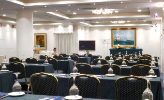 a large , empty conference room with multiple rows of chairs arranged in a semicircle , facing each other at Poseidon Palace