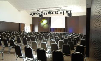 a large conference room with rows of chairs arranged in a semicircle , ready for a meeting or presentation at Protur Biomar Sensatori Resort