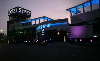 The building where a hotel is located is illuminated with neon lights at night for special occasions at Sex and the City Motel