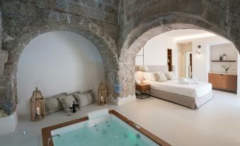 a room with two beds and a bathtub in the middle of the room , creating a unique and cozy atmosphere at Masseria Amastuola Wine Resort