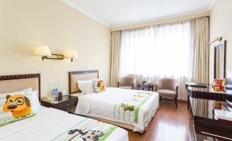 a hotel room with two beds , one on the left and one on the right side of the room at Airport Hotel