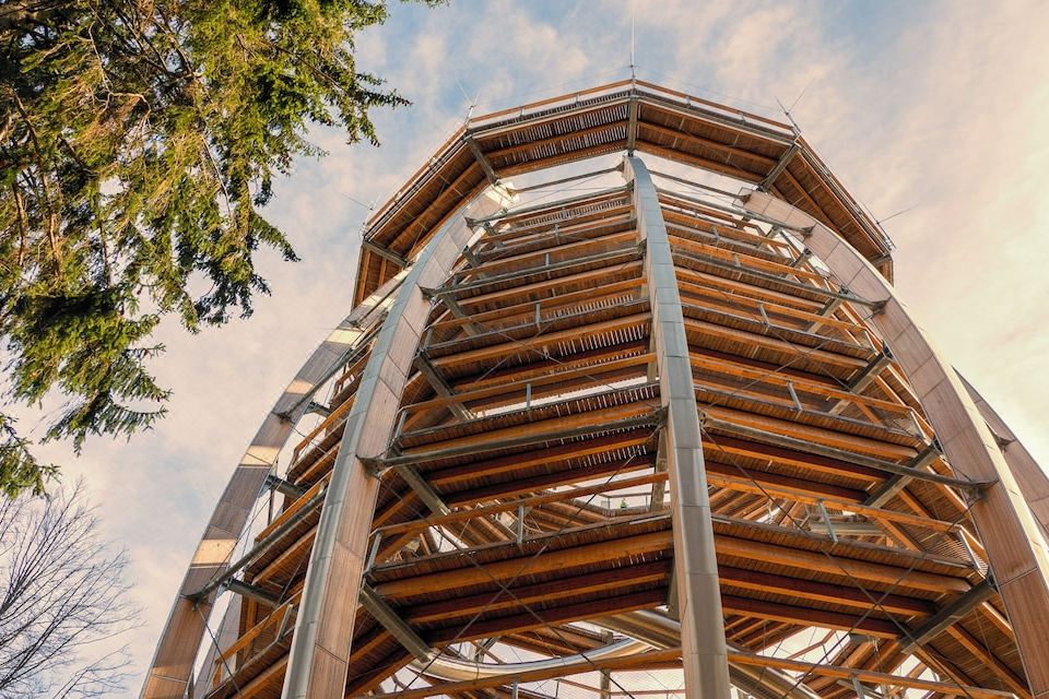 a large , multi - level structure with wooden beams and metal supports is shown against a blue sky at Hotel Esplanade