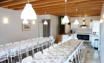 a large dining room with multiple tables and chairs , some of which are covered in white tablecloths at La Tulipe