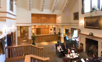 a large hotel lobby with high ceilings , multiple couches , and chairs arranged in a seating area at Lancaster House Hotel