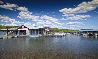 a boat dock on a body of water , with several boats docked along the shoreline at Club Wyndham Resort at Fairfield Bay