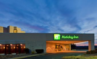 an exterior view of a holiday inn hotel with a large sign above the entrance at Holiday Inn Staunton Conference Center