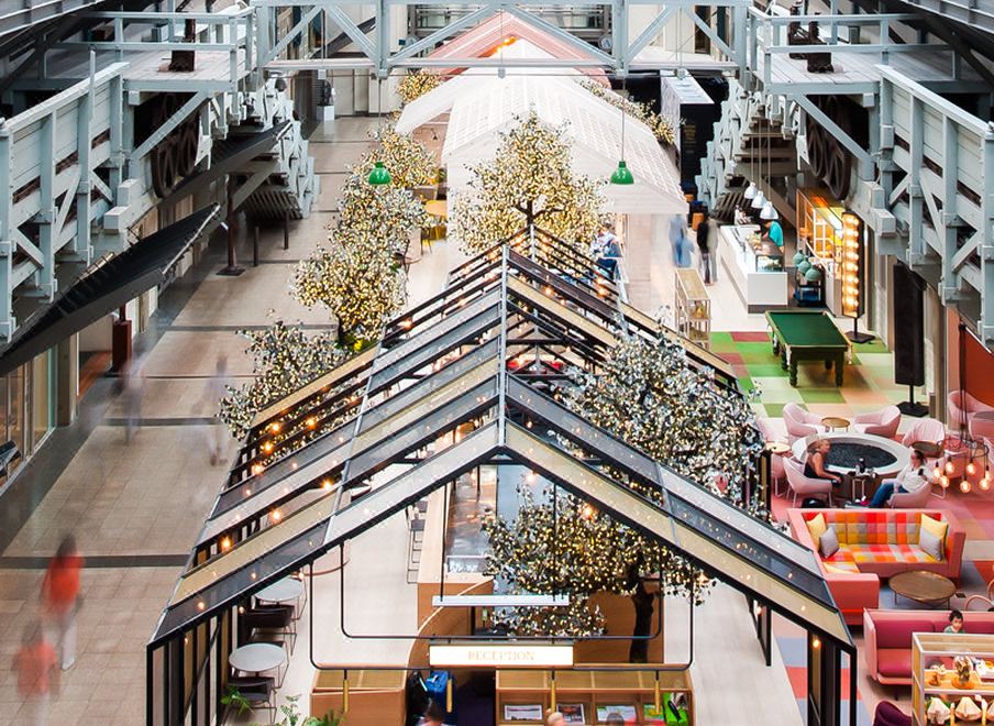 a modern shopping mall with multiple levels , balconies , and a glass structure on the second floor at Ovolo Woolloomooloo