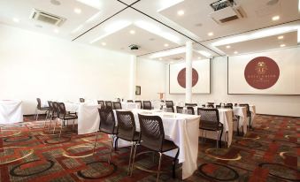 a conference room set up for a meeting with multiple tables and chairs arranged in rows at Hotel Union