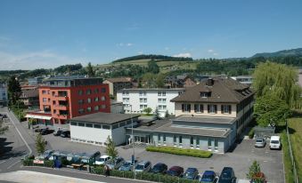 a city street with several buildings , including a hotel and a gas station , in the background at Dialoghotel Eckstein