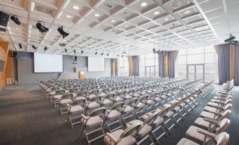 a large conference room filled with rows of chairs and a stage , ready for a meeting or event at Hotel Dubrovnik Palace