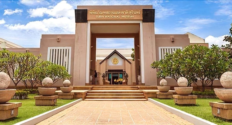 a large entrance to the national museum of thailand with a stone gate and steps leading up to it at Slive Hotel
