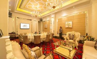 A spacious room is arranged with tables and chairs for events or formal dining at Rio Hotel