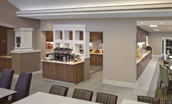 a dining area with a variety of food and beverages on display , including coffee machines at Residence Inn Hartford Avon