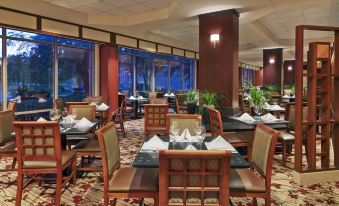 a large dining room with multiple tables and chairs , creating an inviting atmosphere for guests at Sheraton Suites Chicago Elk Grove