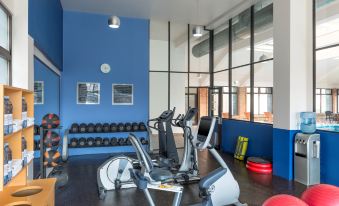 a well - equipped gym with various exercise equipment , including a treadmill , stationary bike , and weights at Four Points by Sheraton Saltillo