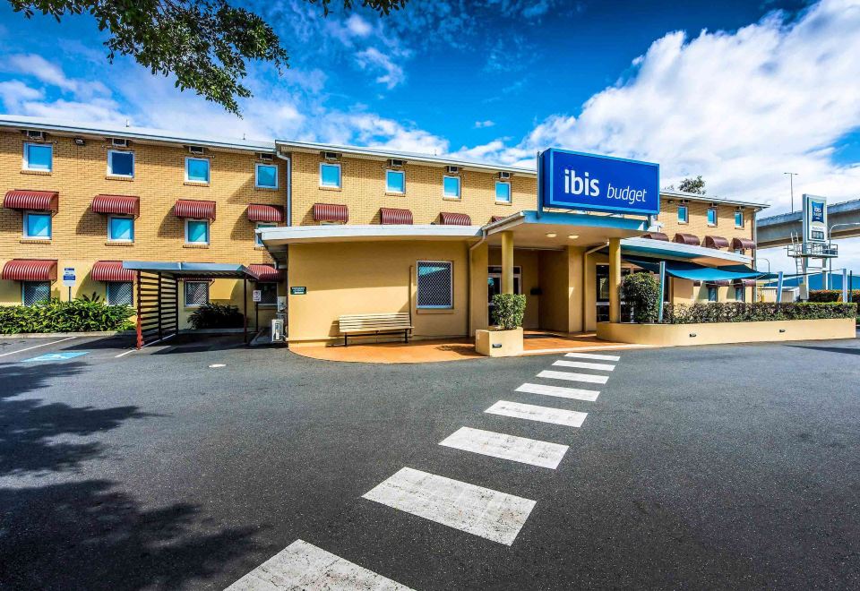 an exterior view of a hotel or motel , located in a city setting at Ibis Budget Brisbane Airport