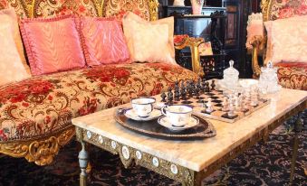 a living room with a large couch , a chess table , and several cups on the table at Charlemont House